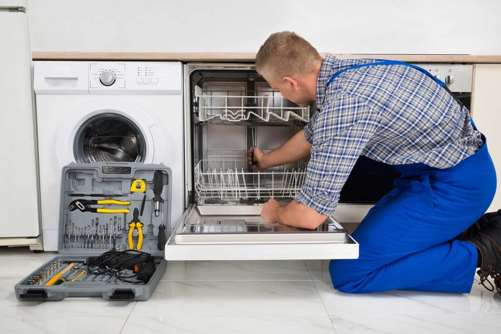 technician fixing a dishwasher repair arlington