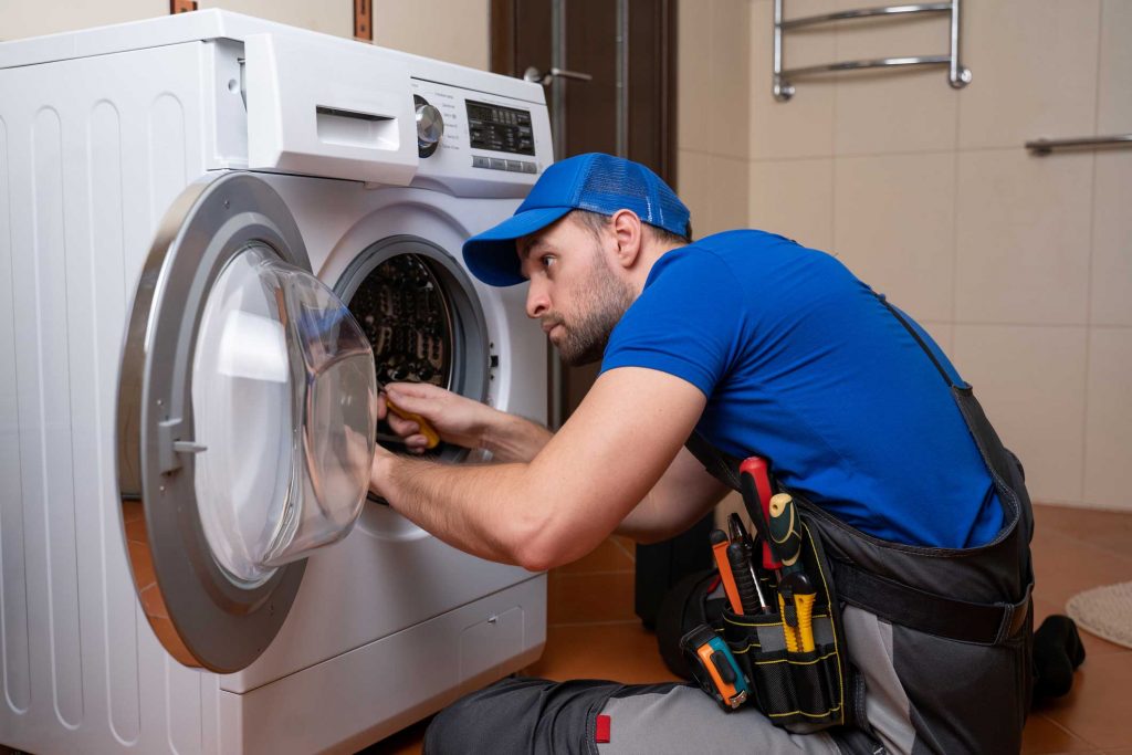 a technician repairing a washer and dryer repair arlington